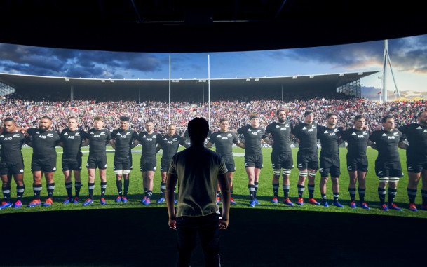 Man facing All Blacks on wide panoramic screen