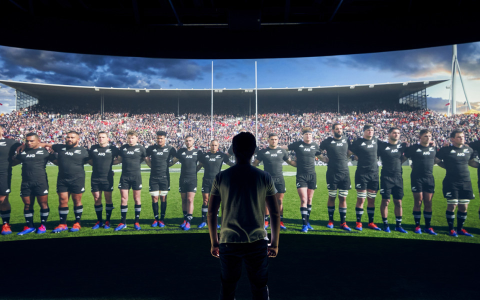 Man facing All Blacks on wide panoramic screen