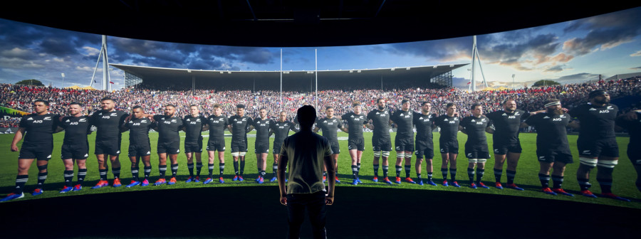 Man facing All Blacks on wide panoramic screen