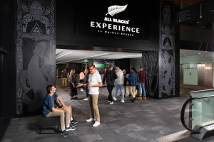 Man standing in front of the entrance to the All Blacks Experience 