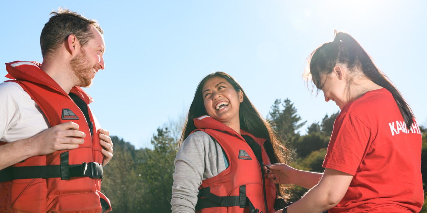 Happy couple get red life jackets fitted